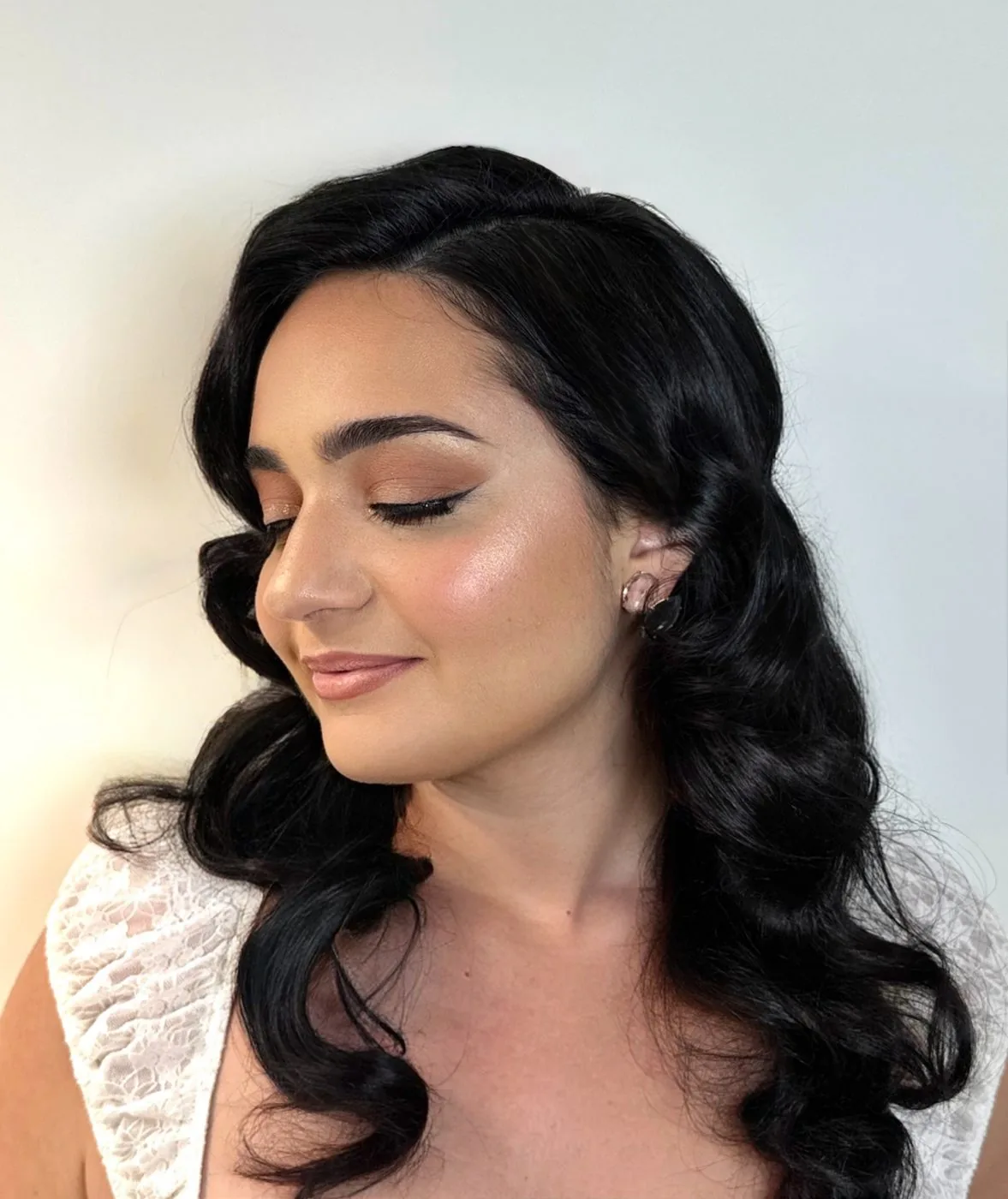 Bridal hair styled in side-swept waves