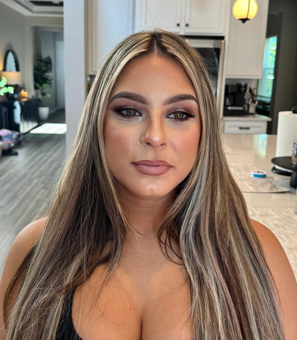 Soft glam makeup with sleek blonde hair